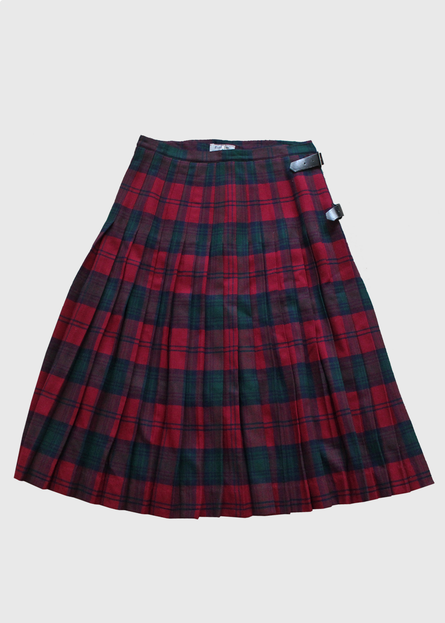 Vintage 1980s pleated plaid skirt by Burberry, made in Scotland from soft 100% wool. Red/blue/green tartan plaid with real leather double buckle detail.