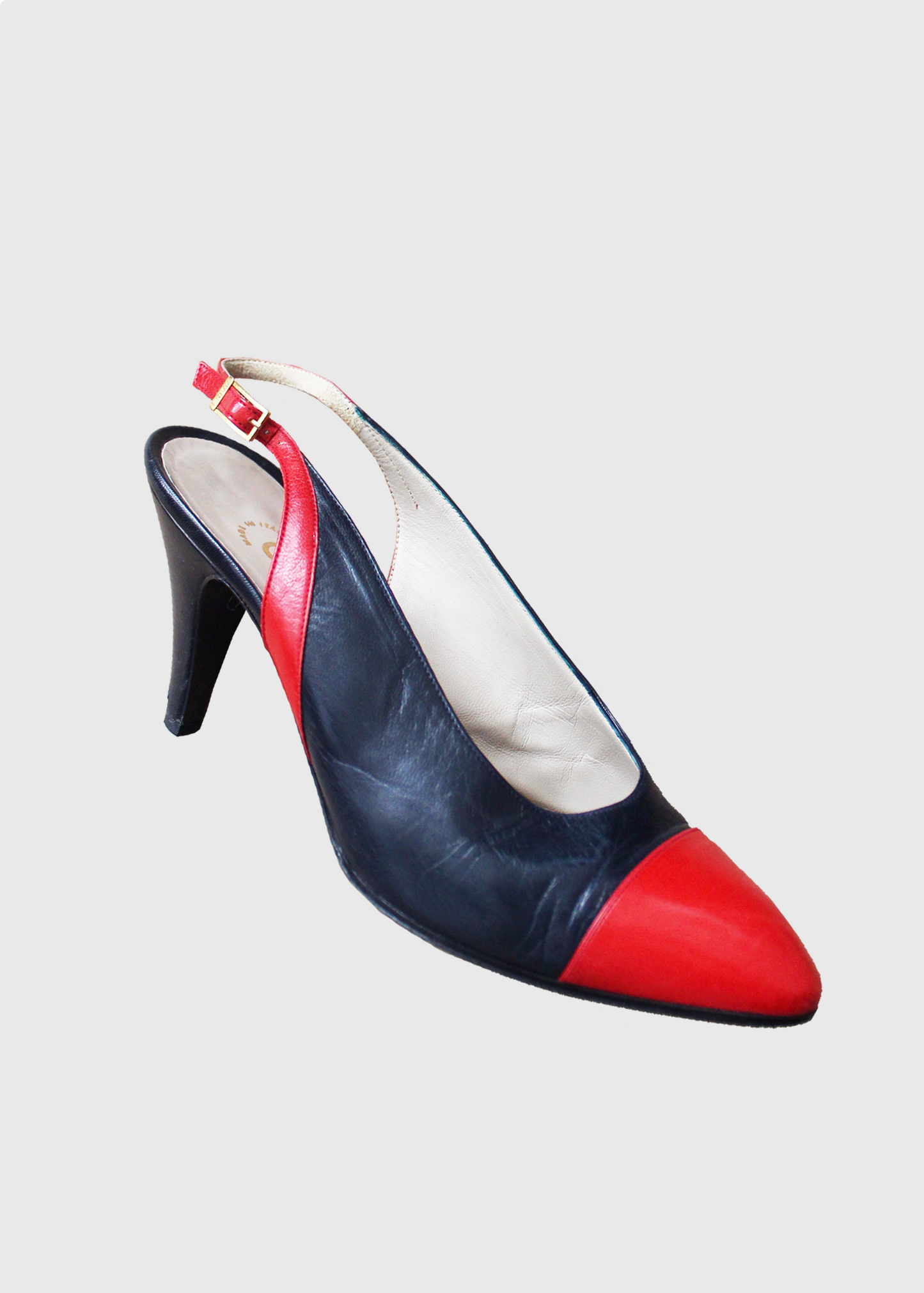Deep blue and bright red leather slingback heels by Chanel with gold clasp hardware on the outside slingback ankle strap.