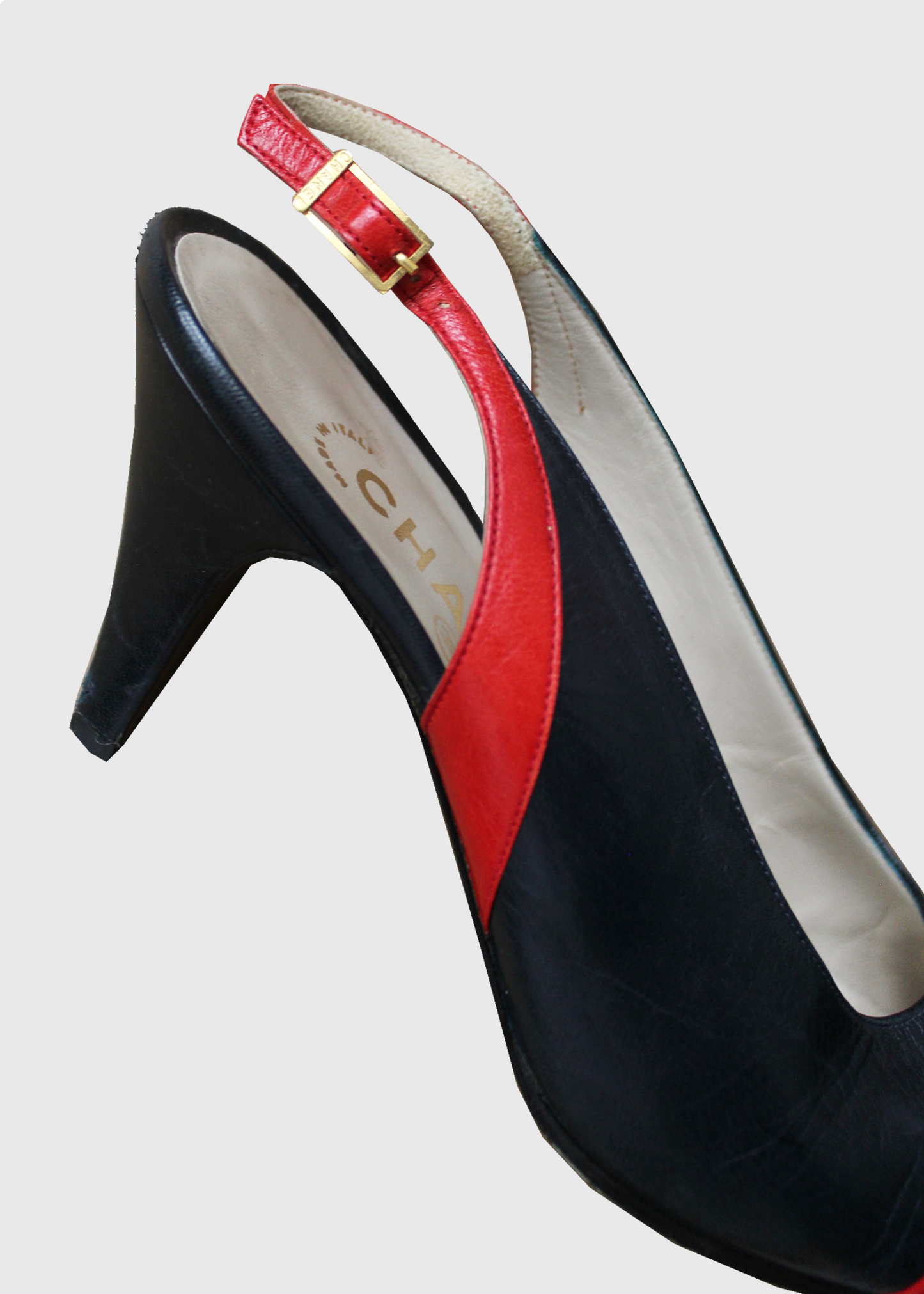Deep blue and bright red leather slingback heels by Chanel with gold clasp hardware on the outside slingback ankle strap.