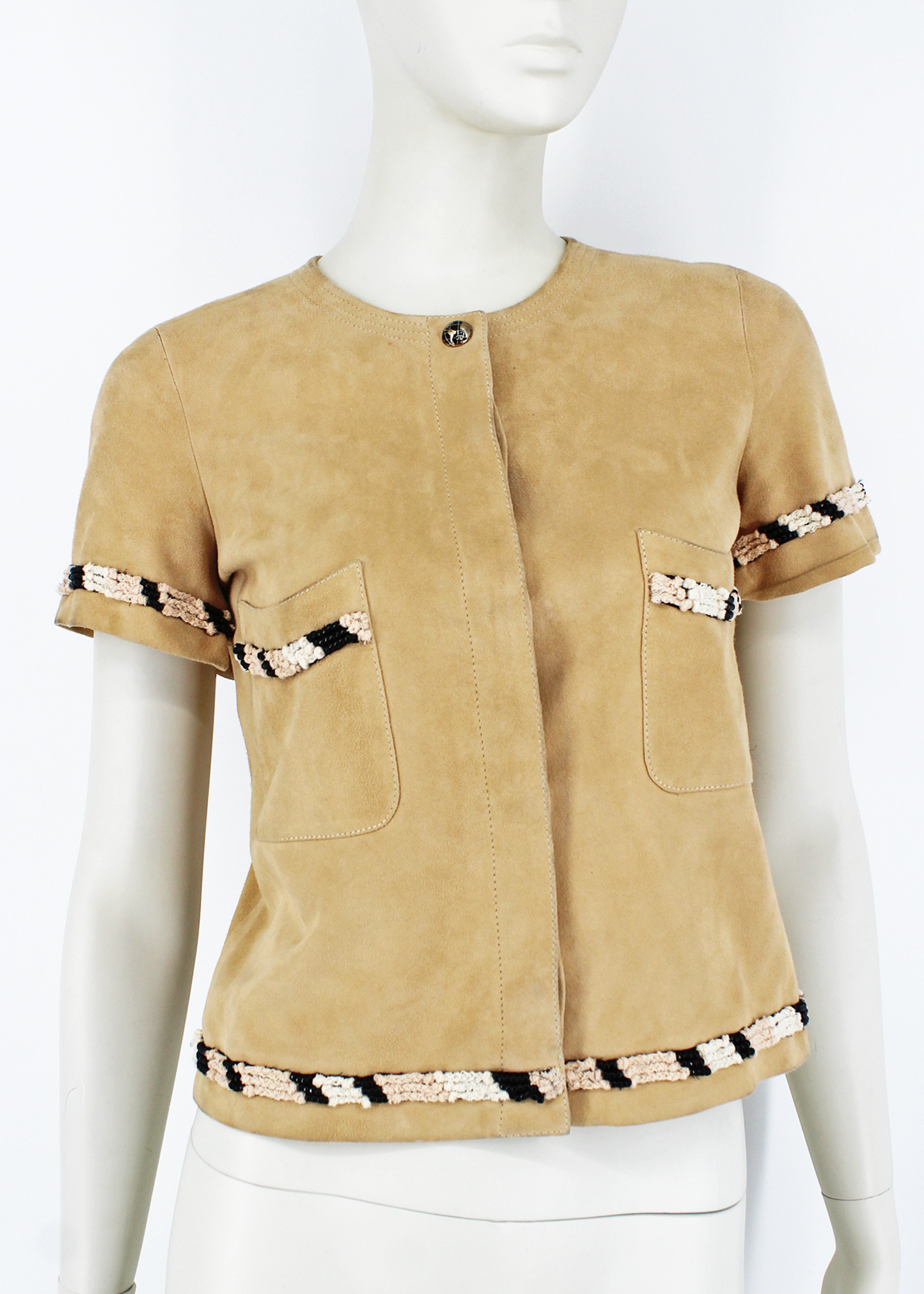 Cropped, short-sleeved suede jacket by Chanel, featuring globe-printed CC enameled buttons and beaded, threaded, and knotted trims throughout. Two front patch pockets