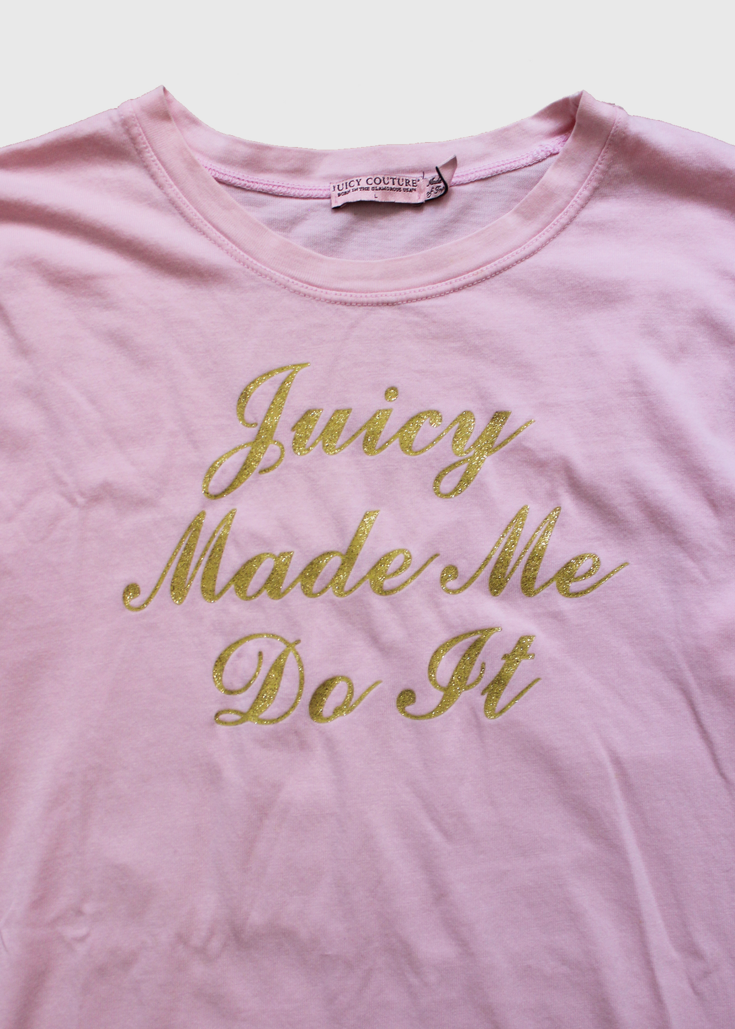 Close up of the cursive gold "Juicy Made Me Do It" on the front of the shirt