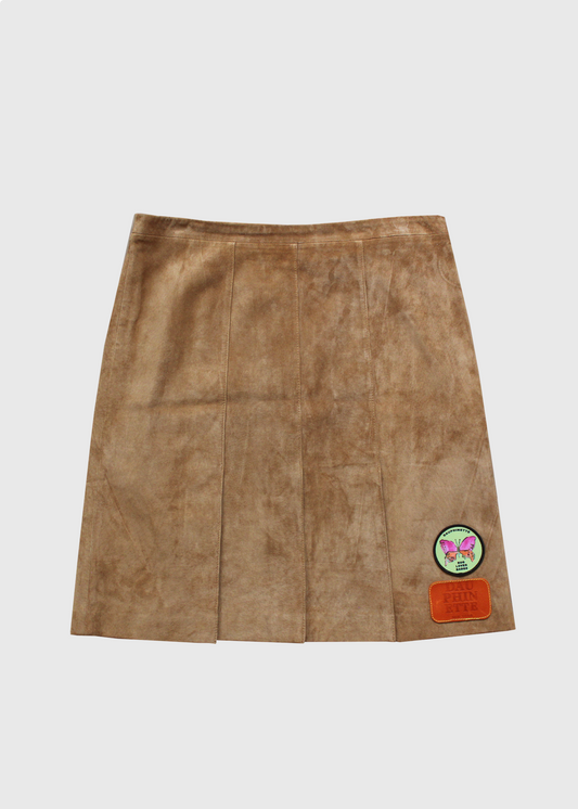 Camel suede pleated mini skirt with signature Dauphinette text and Dauphinette pink and green butterfly patches.
